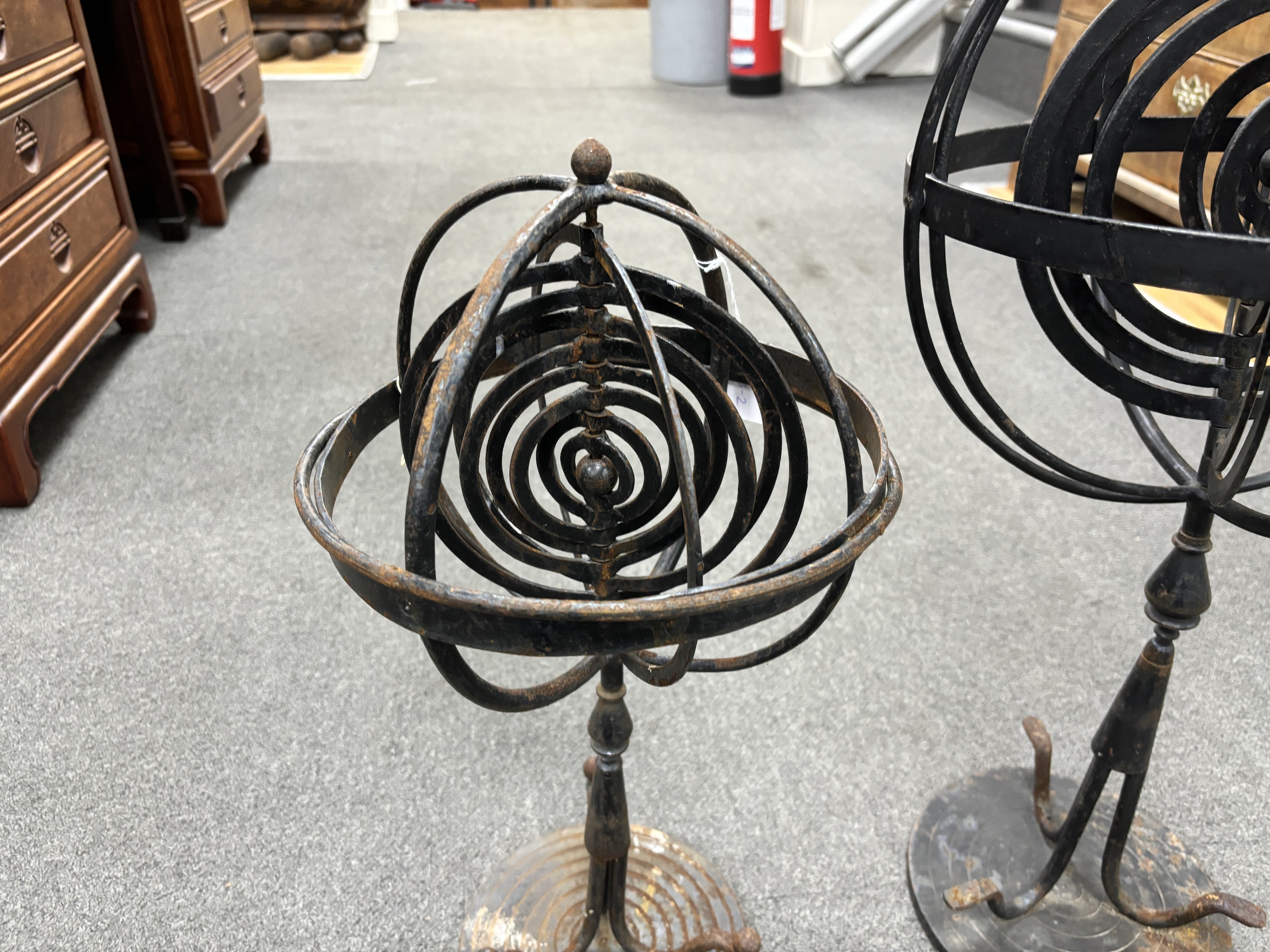 Two wrought iron armillary spheres, largest 65cm